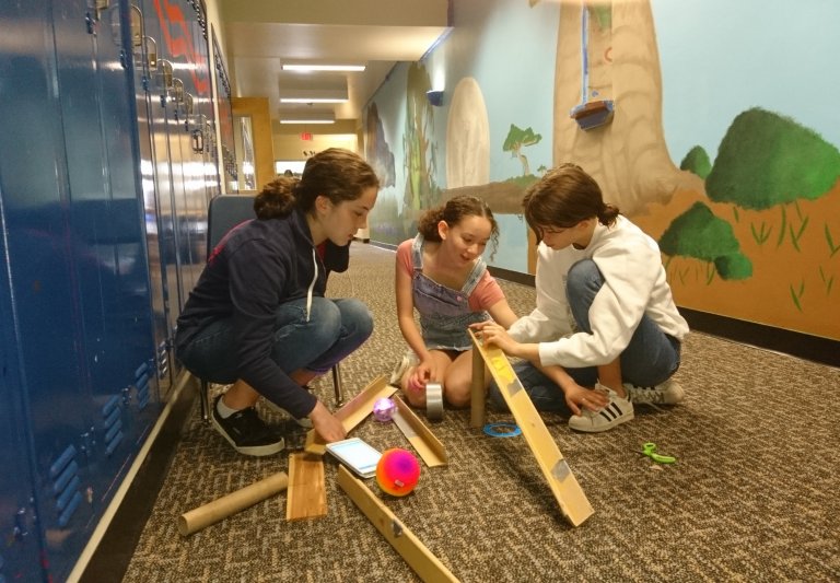 Saturday Academy students working on a Rube Goldberg machine