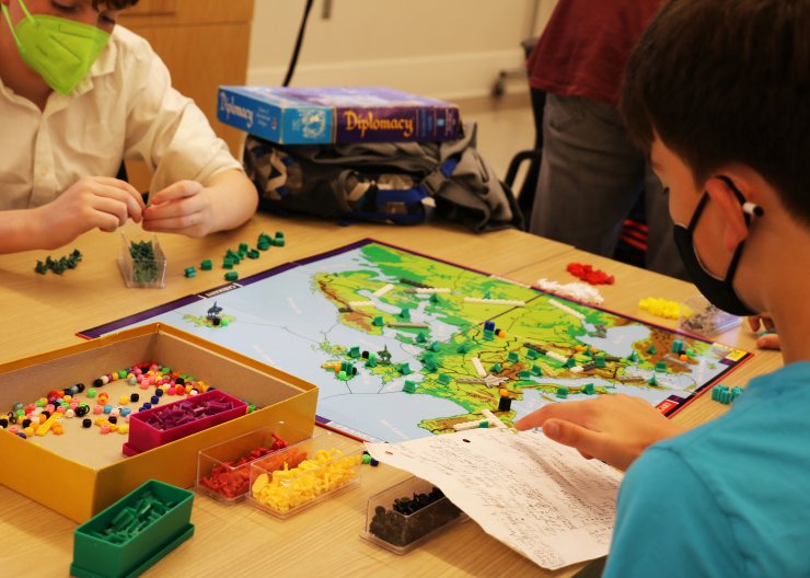 Two young students play test a board game in Saturday Academy’s Gamemaster summer camp