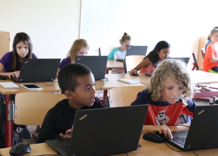 students programming at laptops at Saturday Academy