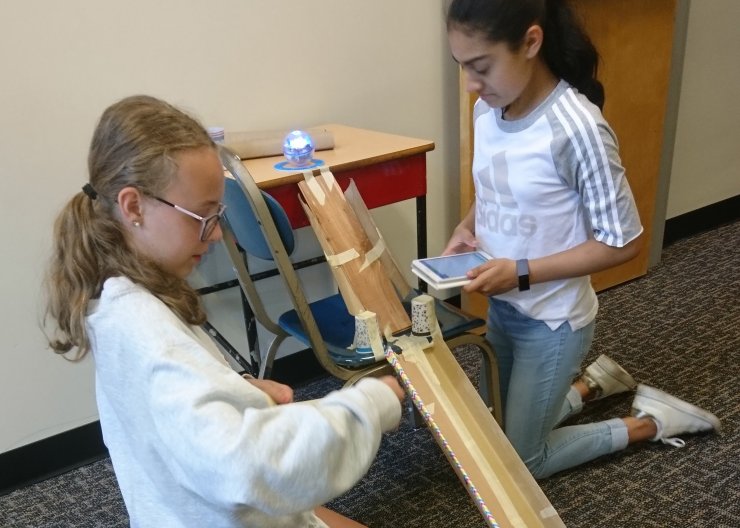Two Saturday Academy students work on building a ramp system in our Kinectic Machines summer camp