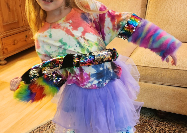 A young Saturday Academy camper is dressed up and ready for imaginary play