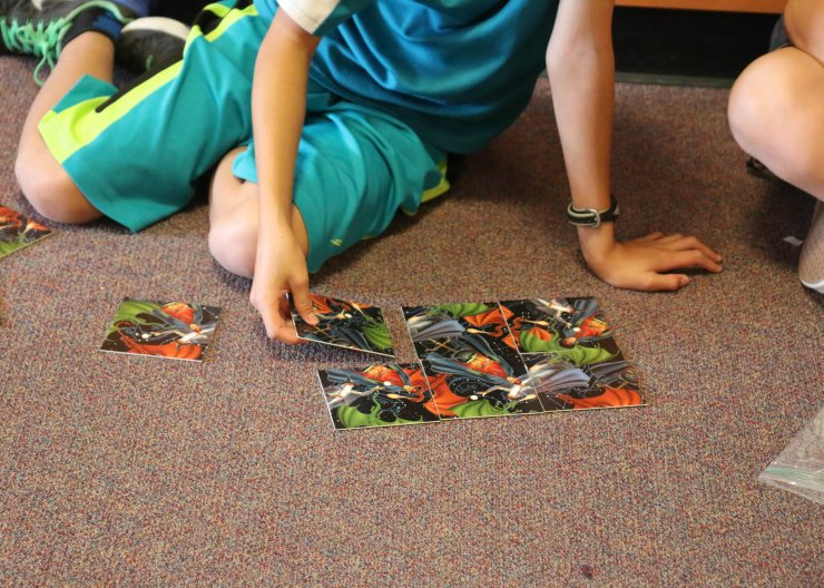A student works on a puzzle in Saturday Academy’s Puzzles, Codes, and Games summer camp
