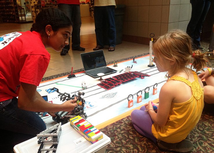 Saturday Academy student learning about engineering from instructor in a summer camp Saturday Academy student learning about engineering from instructor in a summer camp