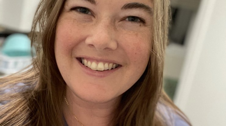 Headshot photograph of a smiling Allison