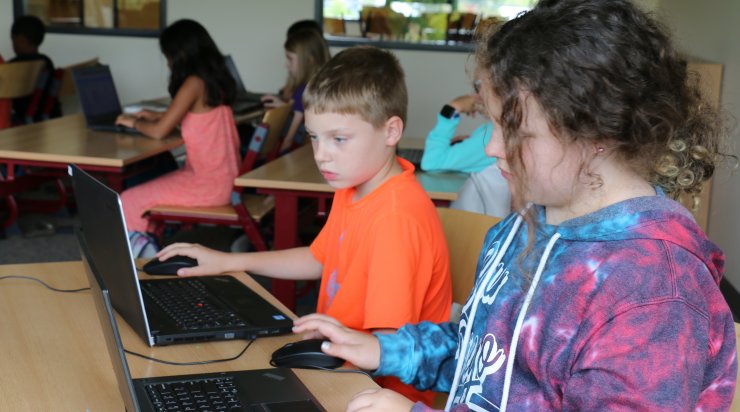 Two Saturday Academy students learning how to code in one of our programming class