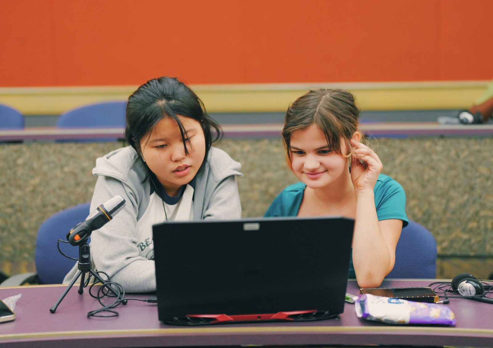 Two kids working on audio project