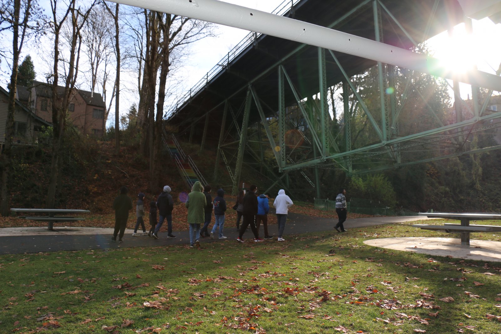 Students in a STEAM Career Tracks Saturday workshop, walking under a bridge in a nature park