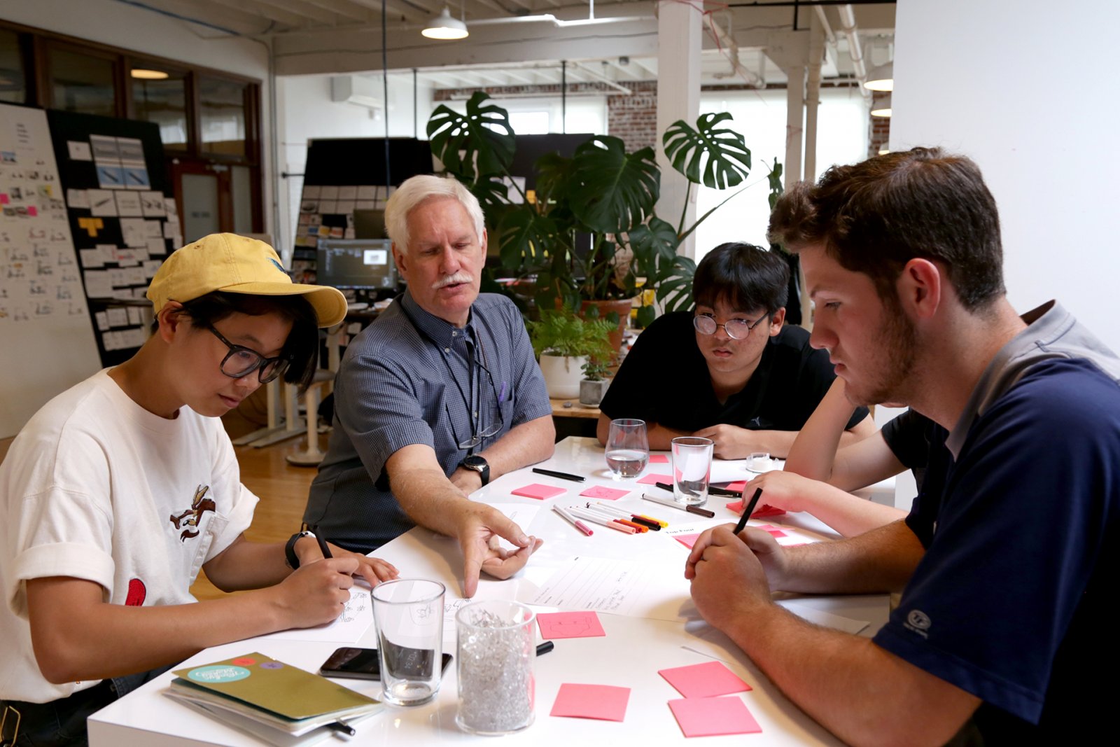 Students studying with instructor at Saturday Academy