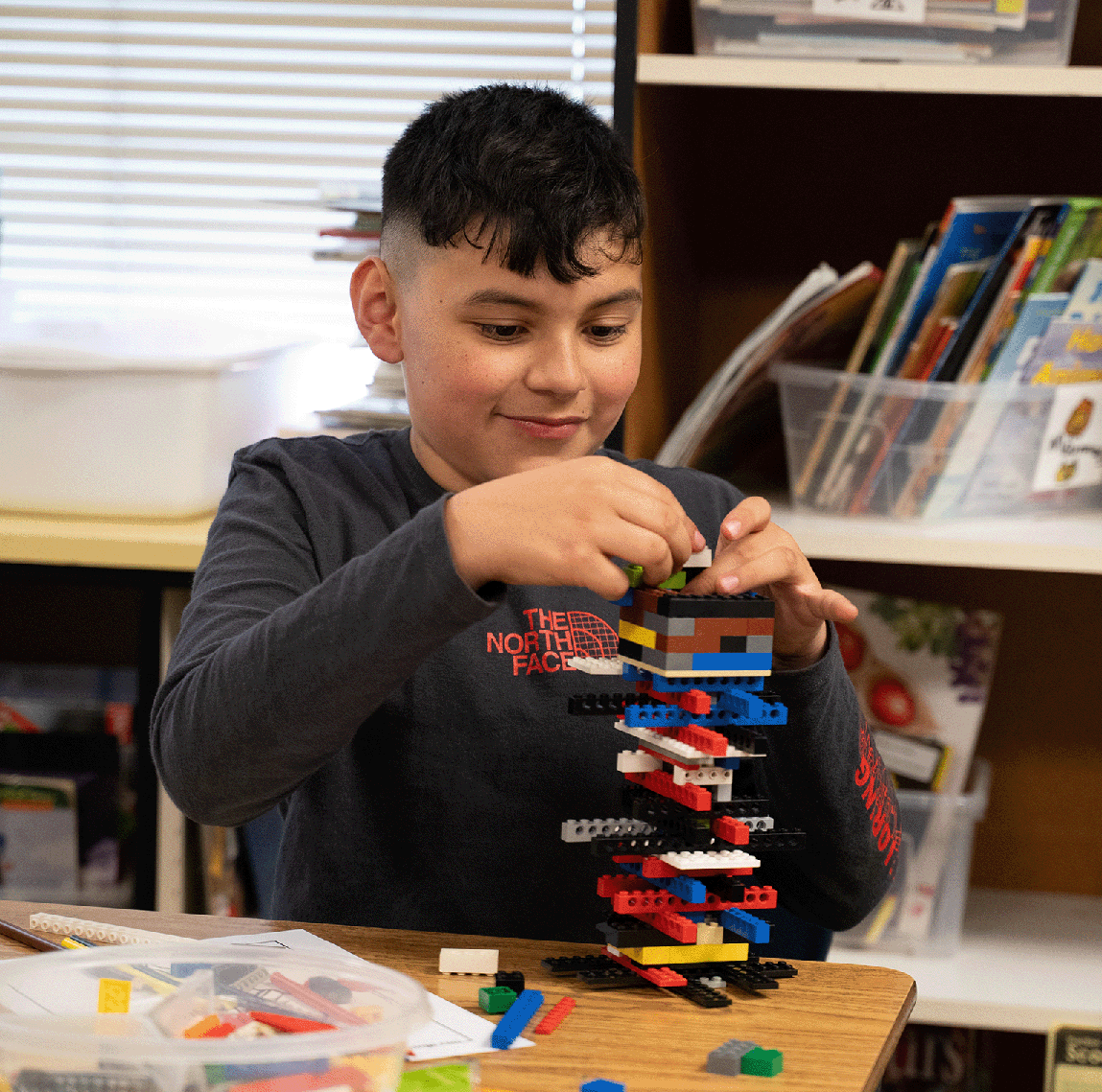 Student Building LEGO tower at residency