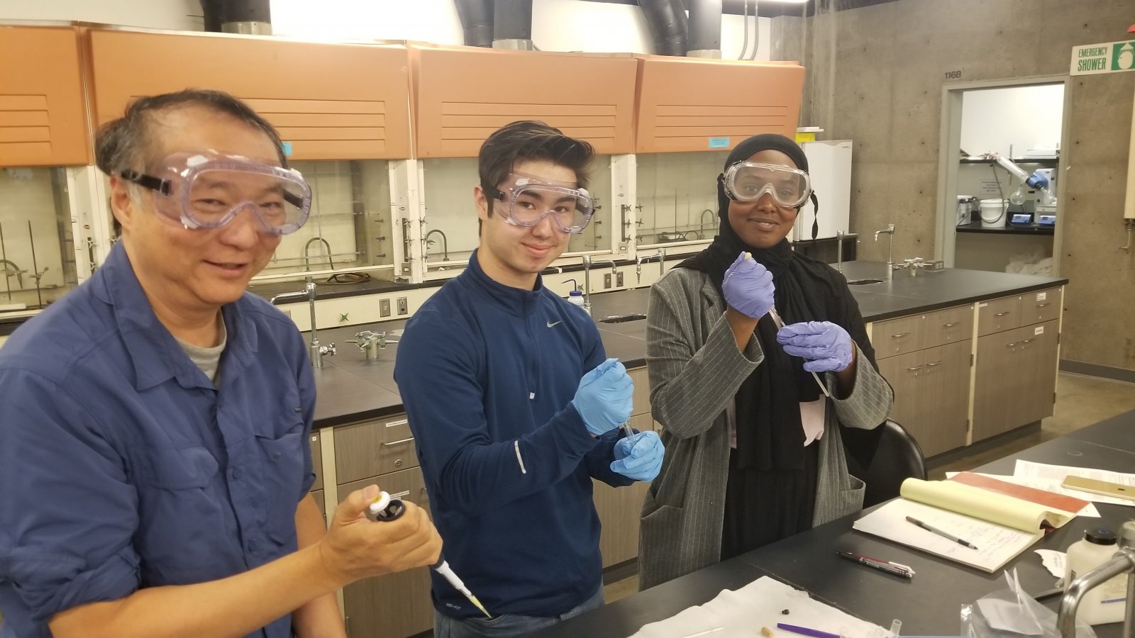 ASE intern working with their mentors in a lab