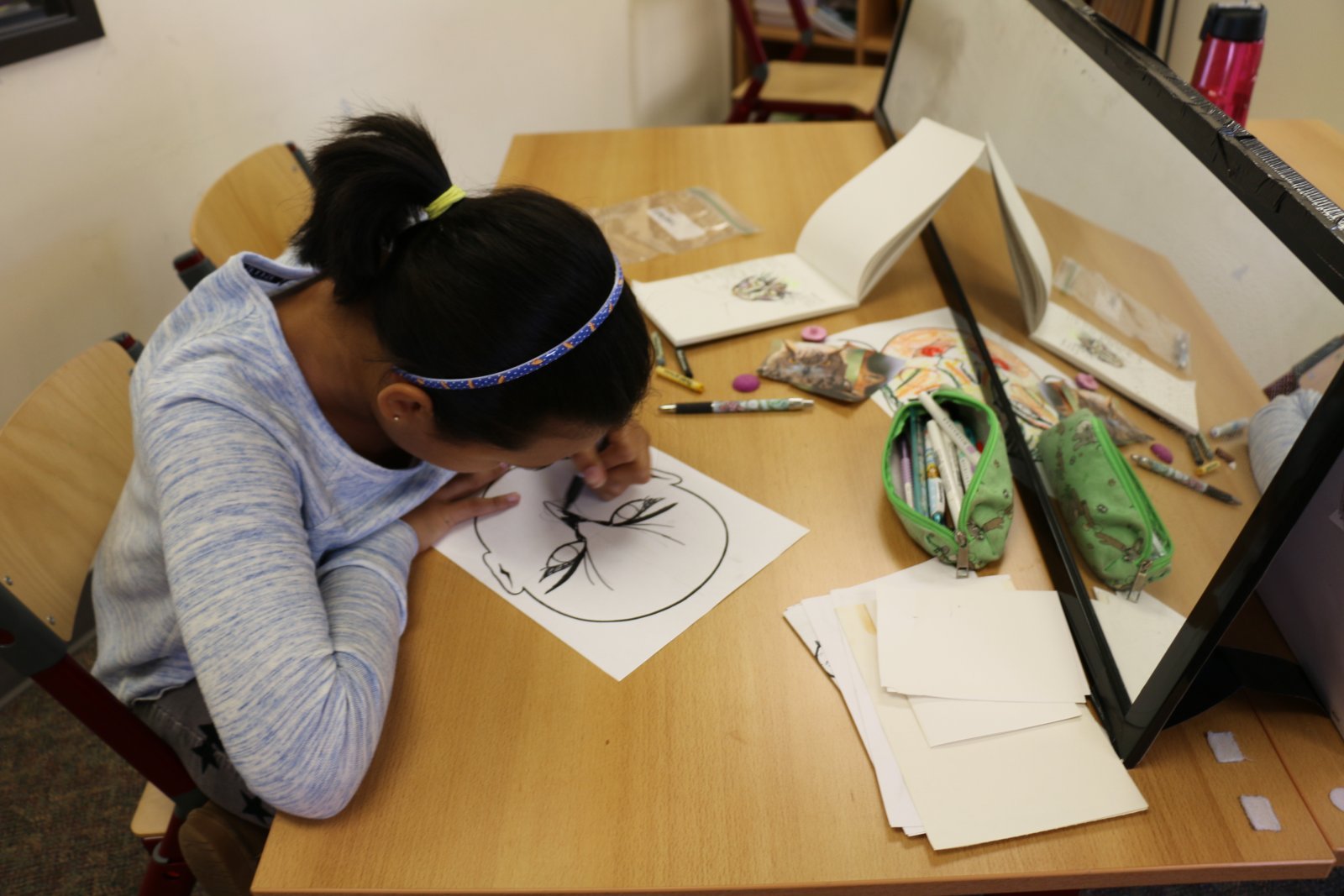 Student working on graphic novel in a Saturday Academy comics class