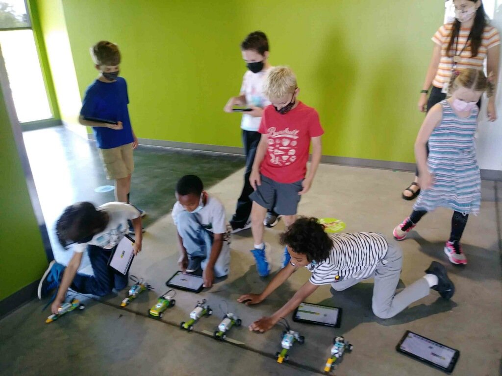 A group of Saturday Academy students getting ready to race LEGO robot cars A group of Saturday Academy students getting ready to race LEGO robot cars