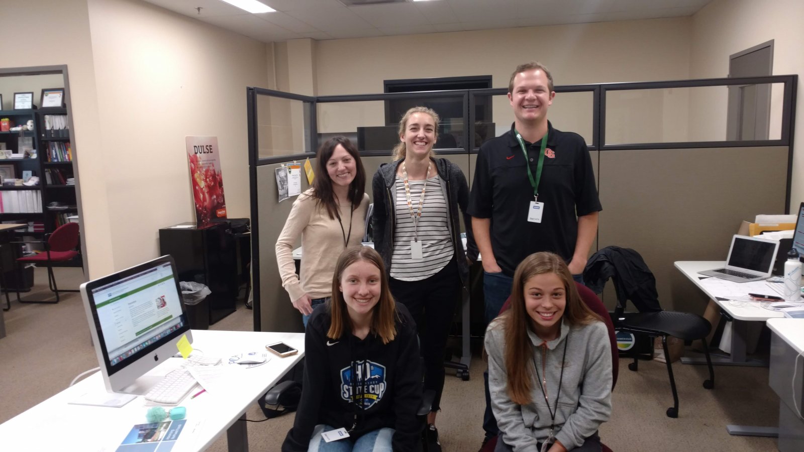 Saturday Academy ASE interns in an office setting with their mentor